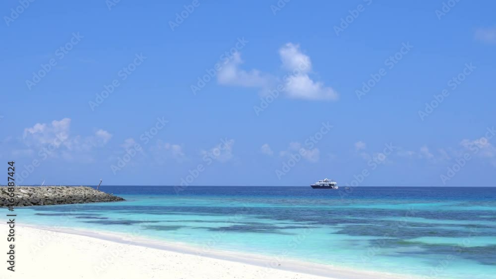 Tropical beach with yacht shipping at the sea. Maldivian destination
Tropical beach with yacht shipping at the sea. Maldivian destination