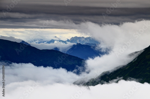 Clouds swirling around and above the ridges of Carnic Alps and Julian Alps in the background, Friuli Venezia Giulia region, Northern Italy, Europe
