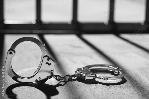 Handcuff and jail bars photo