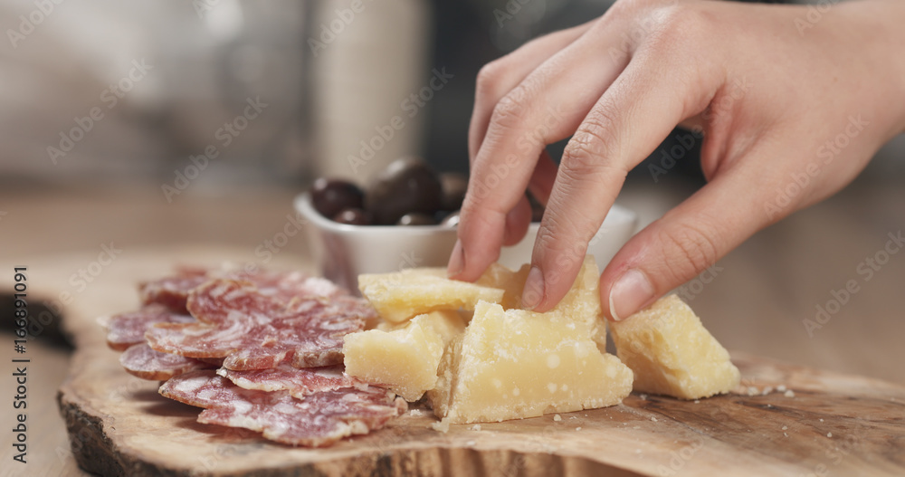 hands taking italian antipasti appetizers from table hands taking italian antipasti appetizers from table