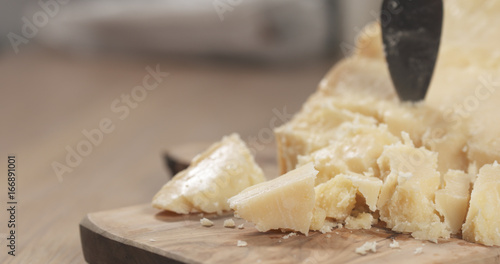 pieces of hard parmesan cheese on olive board