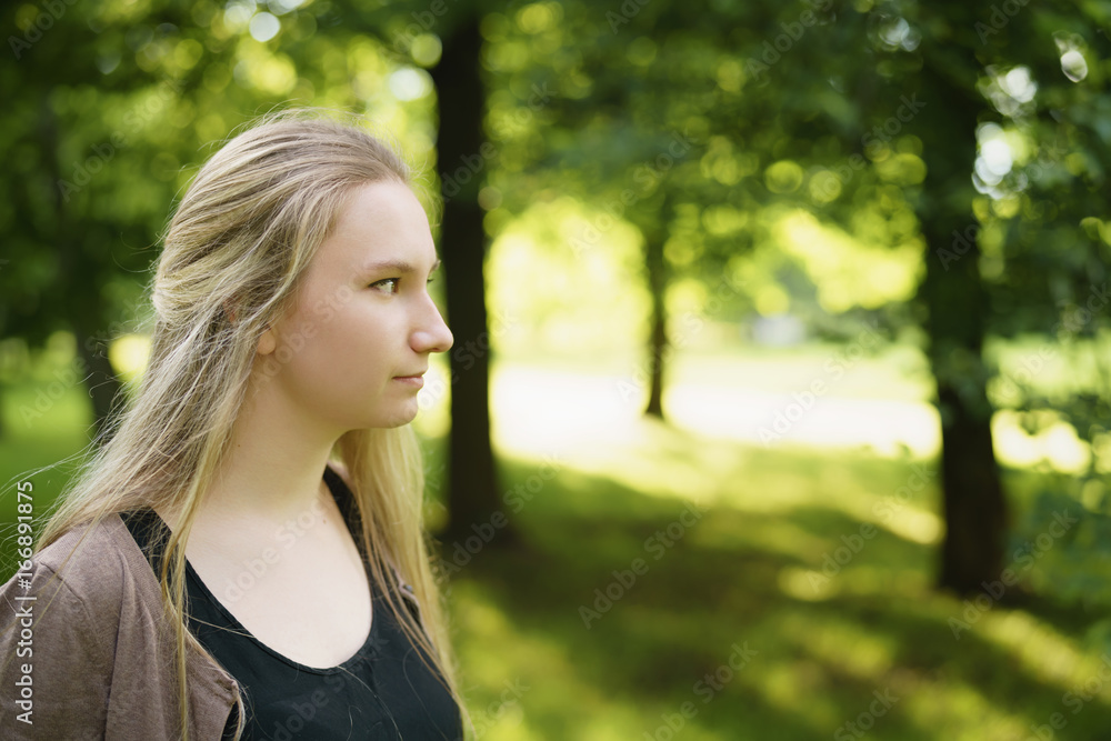 teen girl portrait in green park in sunny summer day teen girl portrait in green park in sunny summer day