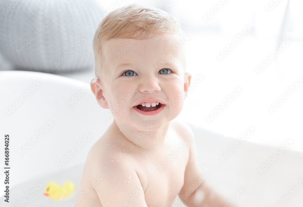 Little baby boy washing in bathtub at home Little baby boy washing in bathtub at home