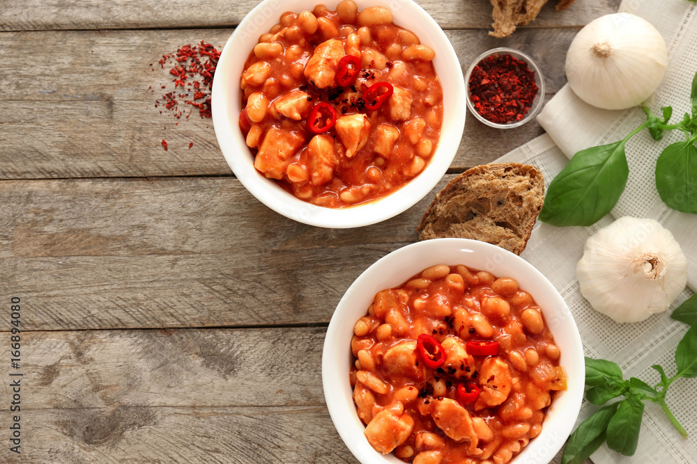 Two bowls with delicious chili turkey on wooden background Two bowls with delicious chili turkey on wooden background