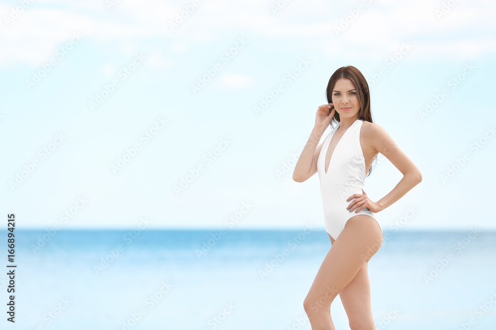 Beautiful young woman near sea on summer day Beautiful young woman near sea on summer day