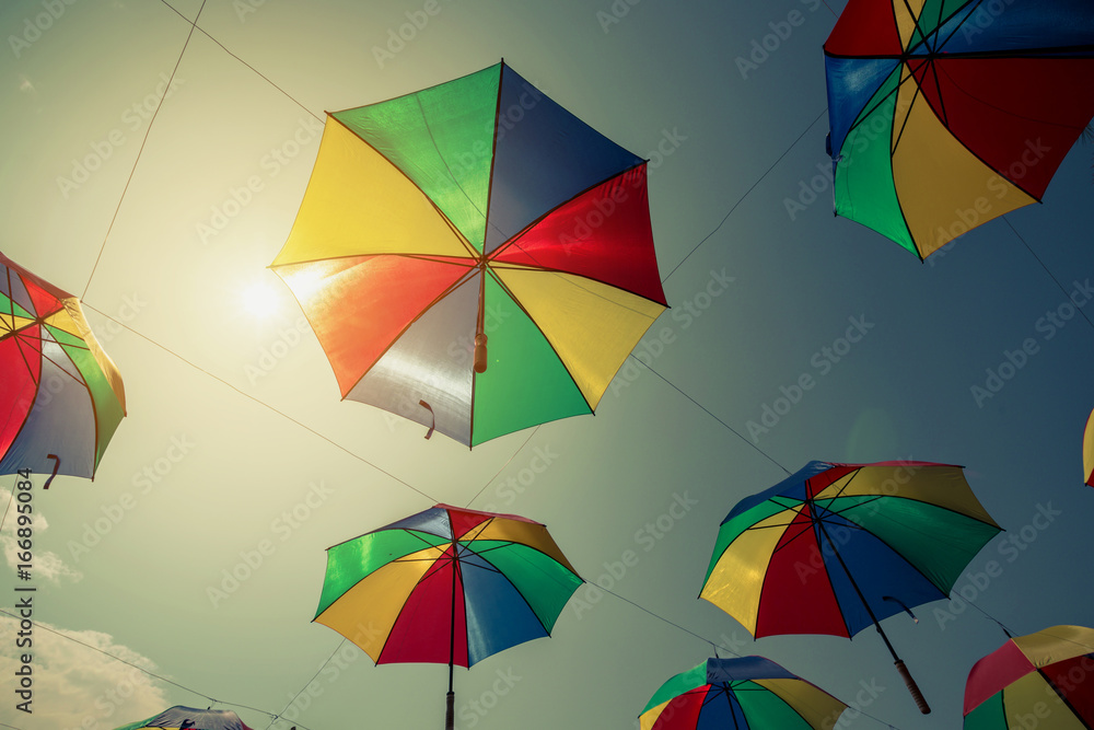 Colorful umbrella street decoration with sunlight. Vintage tone.