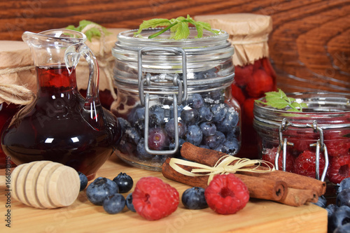 blueberries and raspberries in jars for the winter tea