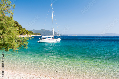 Fototapeta Naklejka Na Ścianę i Meble -  beautiful beach with yacht on dalmatian island, Dalmatia, Croatia