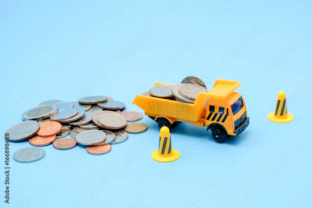 Fototapeta premium save money for investment concept truck toy and Coins on blue background