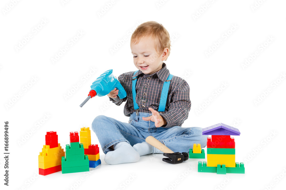 Little boy plays in the builder with tools. isolated over white. Little boy plays in the builder with tools. isolated over white.