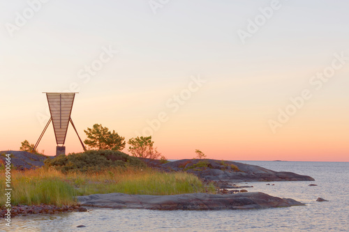 Papier peint Nautical navigation mark / seamark and islets in the archipelago during the sunrise
