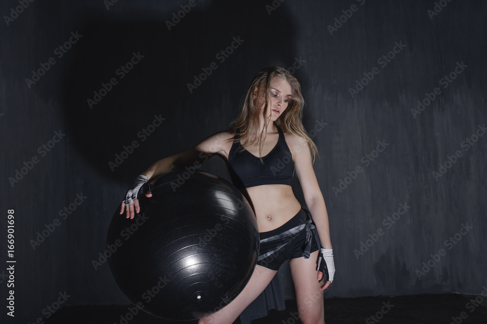 Young girl doing exercises with fit ball at studio Young girl doing exercises with fit ball at studio