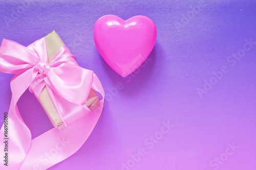 St. Valentines Day greeting card/ Gift box with pink ribbon, heart on a purple background