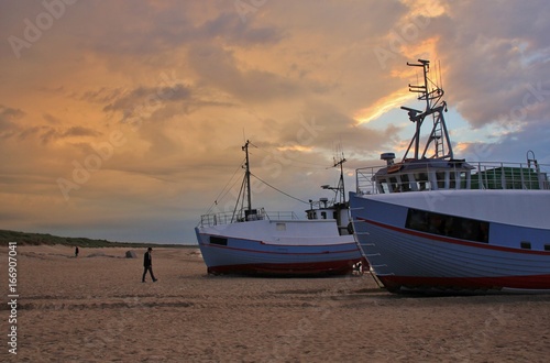 Moody sky over fishing boats at the Thorup Strand, Denmark.
