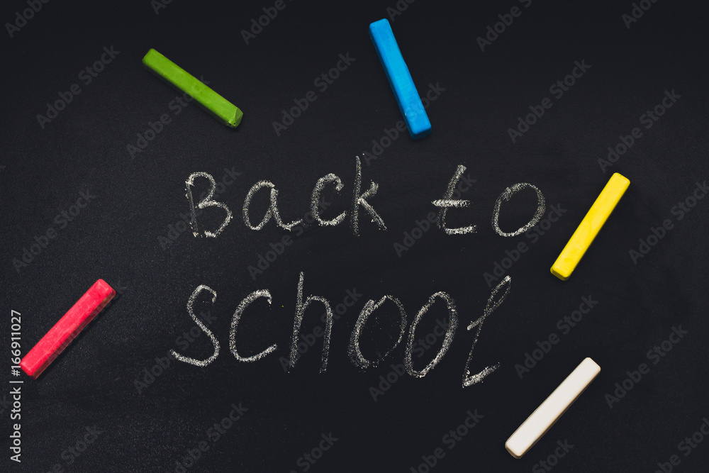 Back to school message on Blackboard inscribed with colorful chalk for background. Back to school message on Blackboard inscribed with colorful chalk for background.