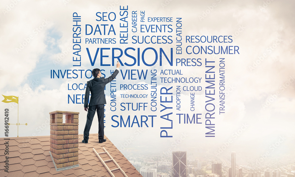 Young businessman standing on house roof and writing leadership Young businessman standing on house roof and writing leadership