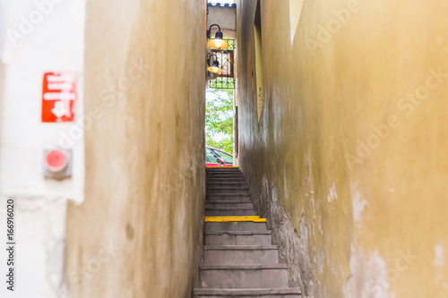 Photography Narrowest street with traffic light in Prague city