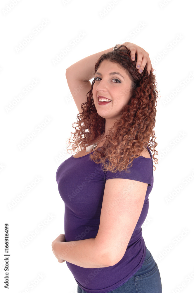 Curvy woman standing in profile and smiling Curvy woman standing in profile and smiling