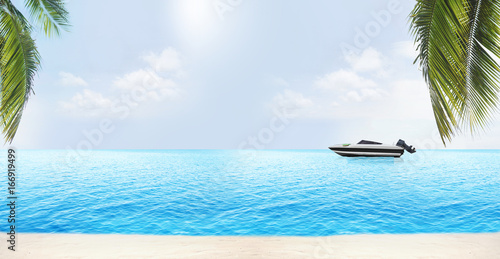 Fototapeta Naklejka Na Ścianę i Meble -  palm leaves at beach with speedboat at light blue water