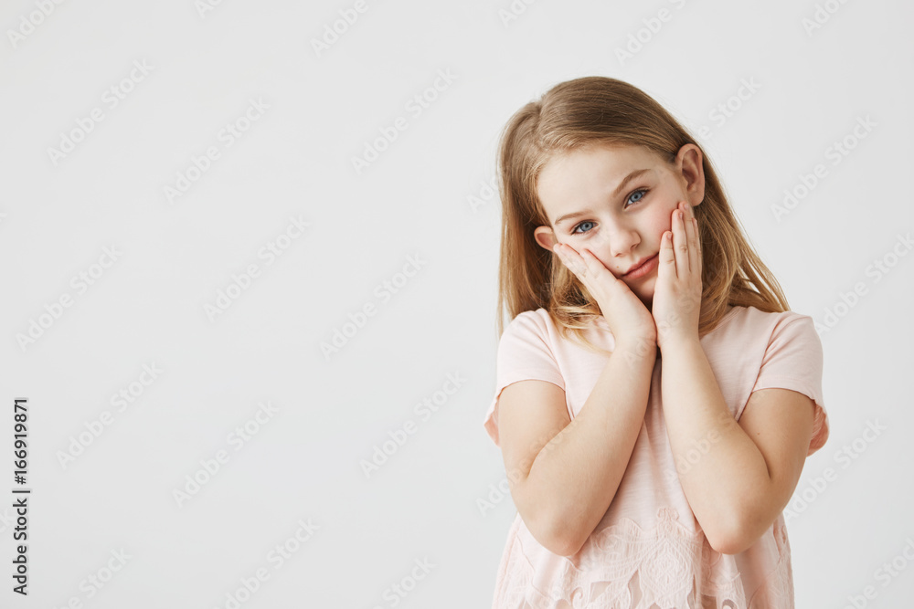 A portrait of a meditative sleepy little blonde girl. The eyes with a color of sea A portrait of a meditative sleepy little blonde girl. The eyes with a color of sea
