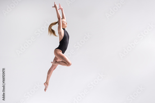 Cheerful young female athlete practicing some exercises