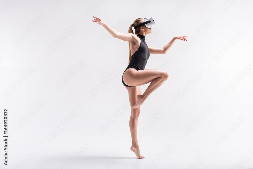 Pensive youthful girl dancing in goggles