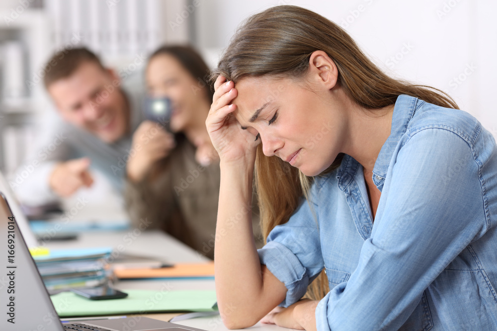 Cyber bullying victim being photographed at office Cyber bullying victim being photographed at office