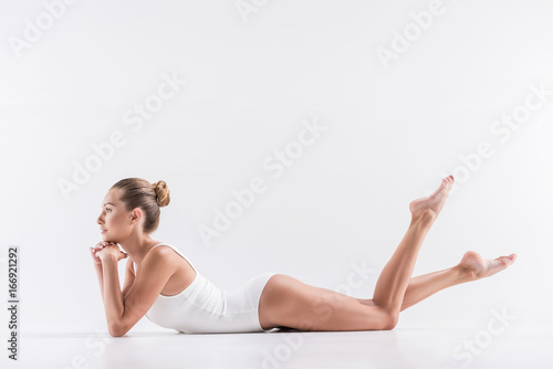 Cheerful young sporty girl having rest while training