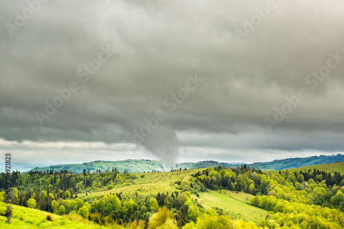 Tornado tip touching mountain. photo