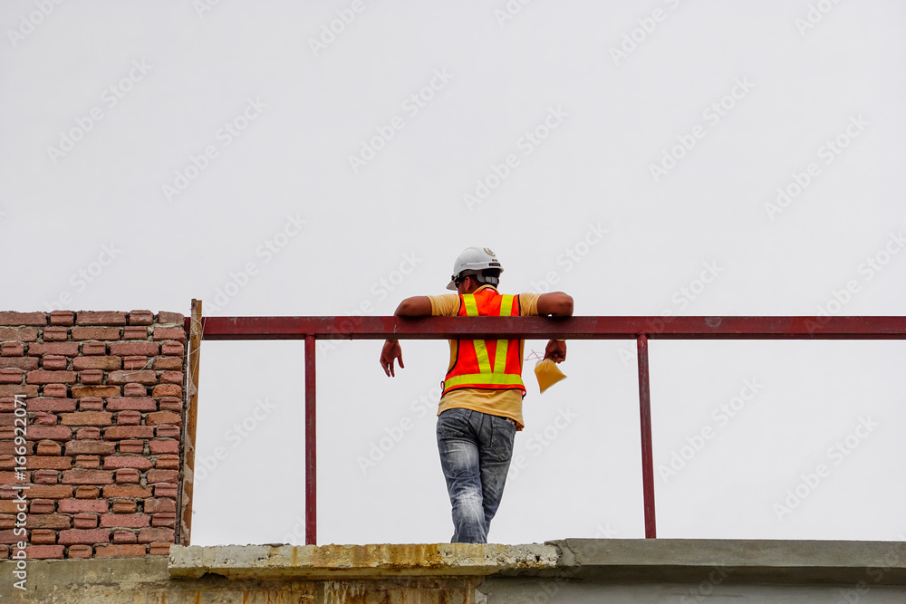 A worker with a construction vest at rest