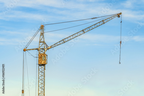 Old abandoned tower crane on a sky background