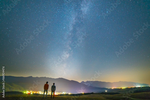 The two friends stand on the background of the stars. night time