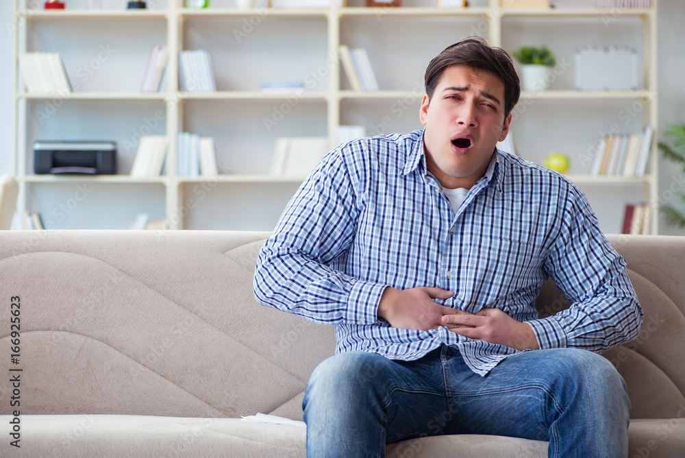 Man suffering from pain at home Man suffering from pain at home