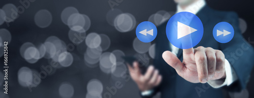 Wallpaper Mural Businessman pressing play button to start or initiate projects Torontodigital.ca