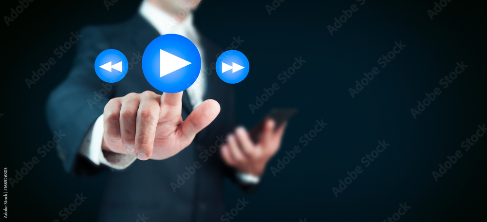 Businessman pressing play button to start or initiate projects Businessman pressing play button to start or initiate projects