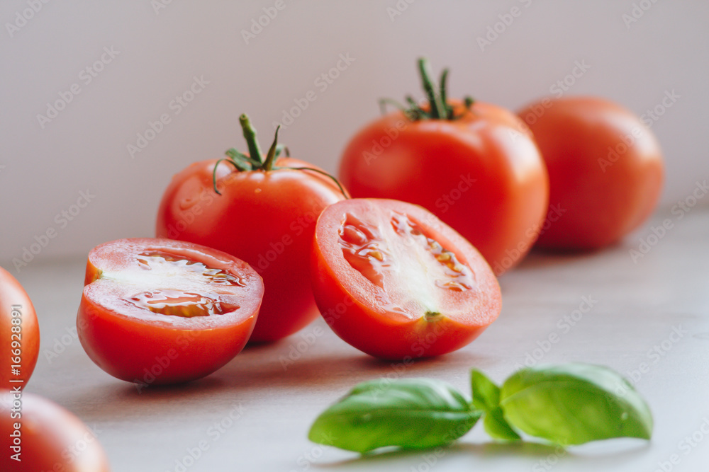 Fresh organic sliced tomatoes and basil leaf Fresh organic sliced tomatoes and basil leaf