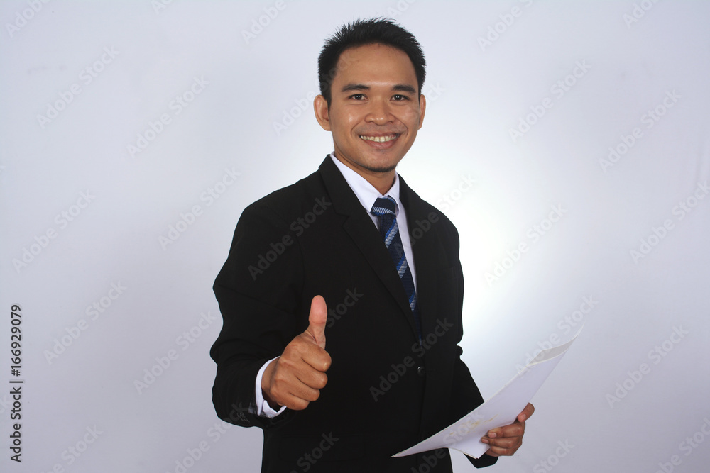 Photo image of a handsome attractive young Asian businessman with thumb up hand isolated on white Photo image of a handsome attractive young Asian businessman with thumb up hand isolated on white