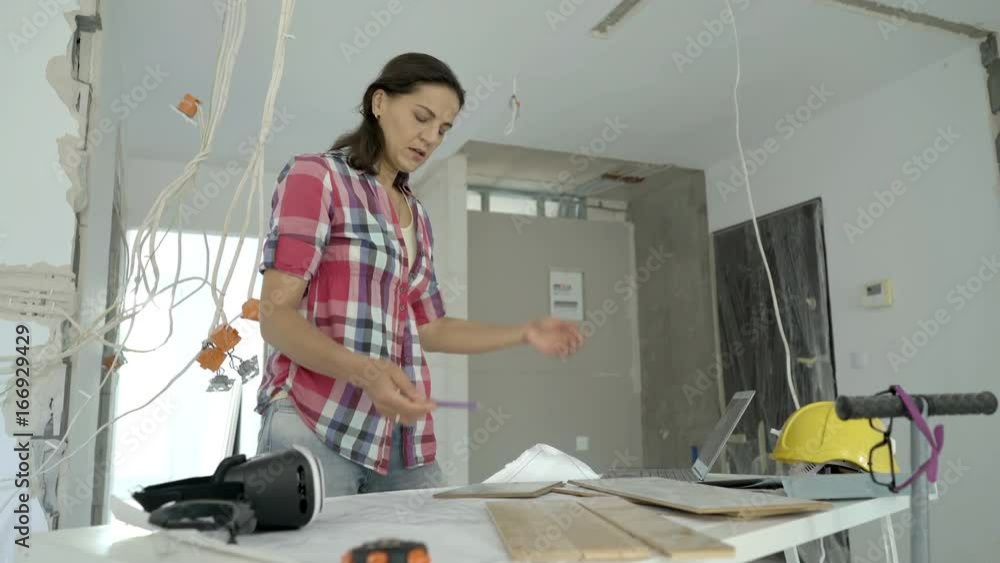 Worried woman checking panels to her new apartment and having problems with them, steadycam shot
Worried woman checking panels to her new apartment and having problems with them, steadycam shot