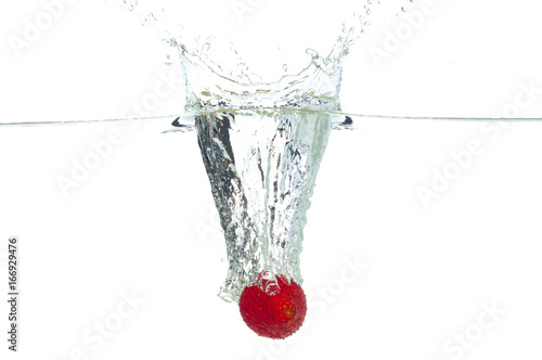 Strawberry falling in the water with splash, isolated on a white background