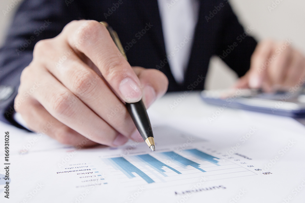 Businessmen working with graph data at office,Finance managers task,Concept business and finance investment Businessmen working with graph data at office,Finance managers task,Concept business and finance investment