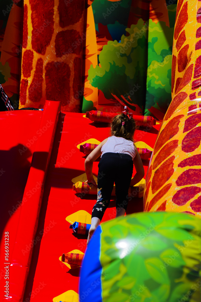 Children play on the inflatable children's playground in the city park. May 28, 2017. Children play on the inflatable children's playground in the city park. May 28, 2017.