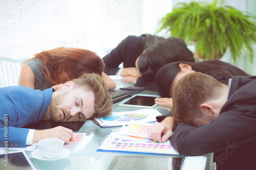 Obraz na płótnie Bored business people sleeping in a meeting colleague.