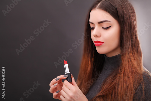 Young asian sexy woman with dark hair using red lipstick