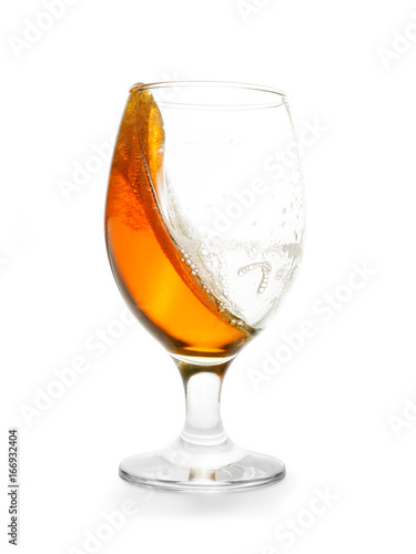 Splashing amber colored beer into glass