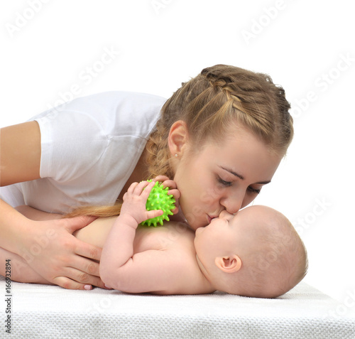Young mother woman holding and kissing in her arms new born infant child baby kid