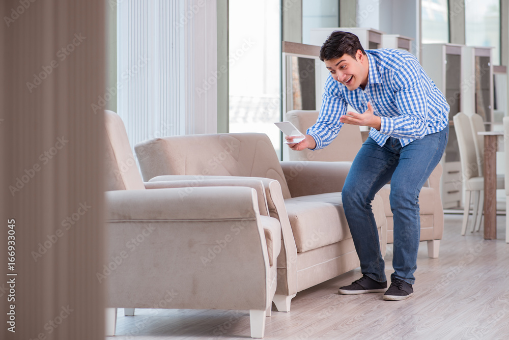Young man shopping in furniture store Young man shopping in furniture store