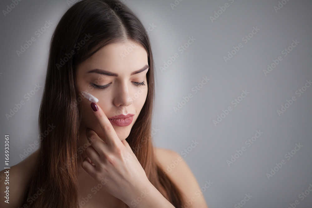 Beautiful Young Woman with Clean Fresh Skin touch own face . Facial treatment . Cosmetology , beauty and spa Beautiful Young Woman with Clean Fresh Skin touch own face . Facial treatment . Cosmetology , beauty and spa