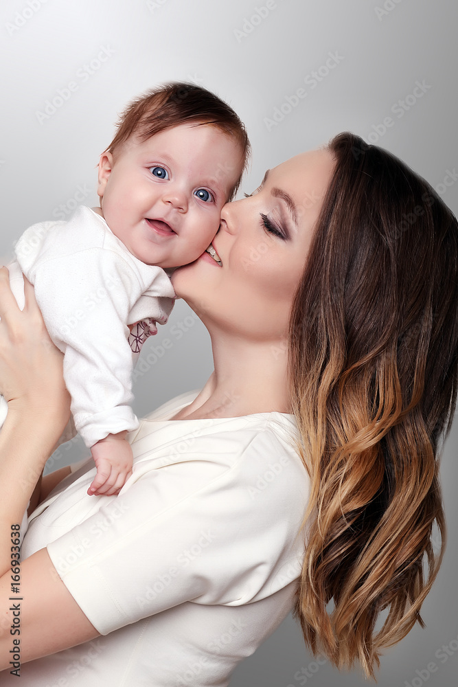 A happy family. Mother holding little daughter in her arms. A happy family. Mother holding little daughter in her arms.