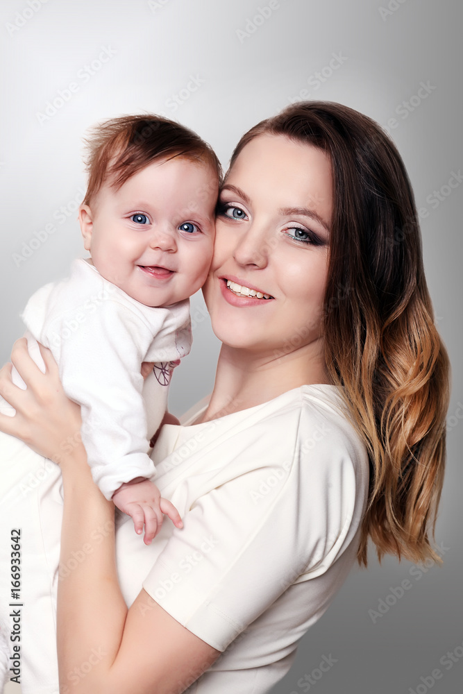 newborn baby in a tender embrace of mother at the window newborn baby in a tender embrace of mother at the window