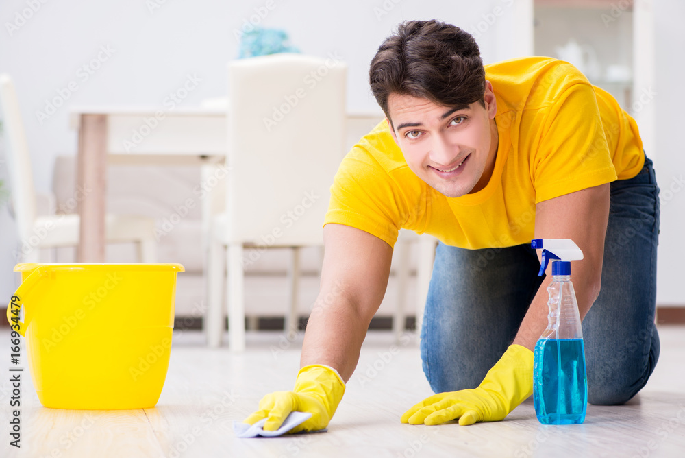 Young man doing chores at home Young man doing chores at home